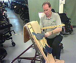 Don Hoerman at NEAT, restores used disability equipment on site in the warehouse