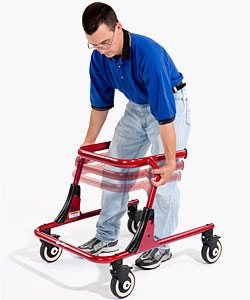 A man, using the knobs on the side of the device, adjusts the height of the red Pacer gait training frame up and down