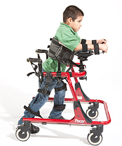 A young boy in a red Pacer uses prompts for pediatric positioning, moving forward in the device