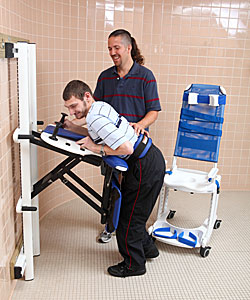 A young adult, with the help from her therapist uses the Rifton Support Station as toilet transfer equipment