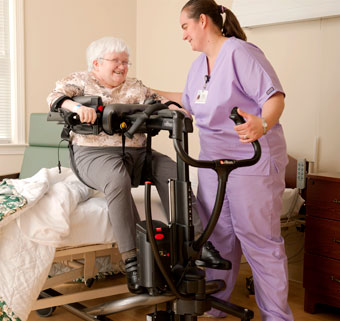 A caregiver using the Rifton TRAM transfer and lift device to position a patient 