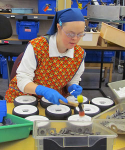 A worker at Rifton busily assembling Pacer casters