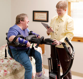 A caregiver uses the Rifton TRAM to perform a  patient transfer seat to seat lift