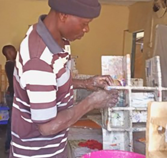 A man building a supportive device for APT Kenya