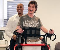 Sean Carter, a former model who suffered a TBI, learns to walk again using the XL Rifton Pacer gait trainer